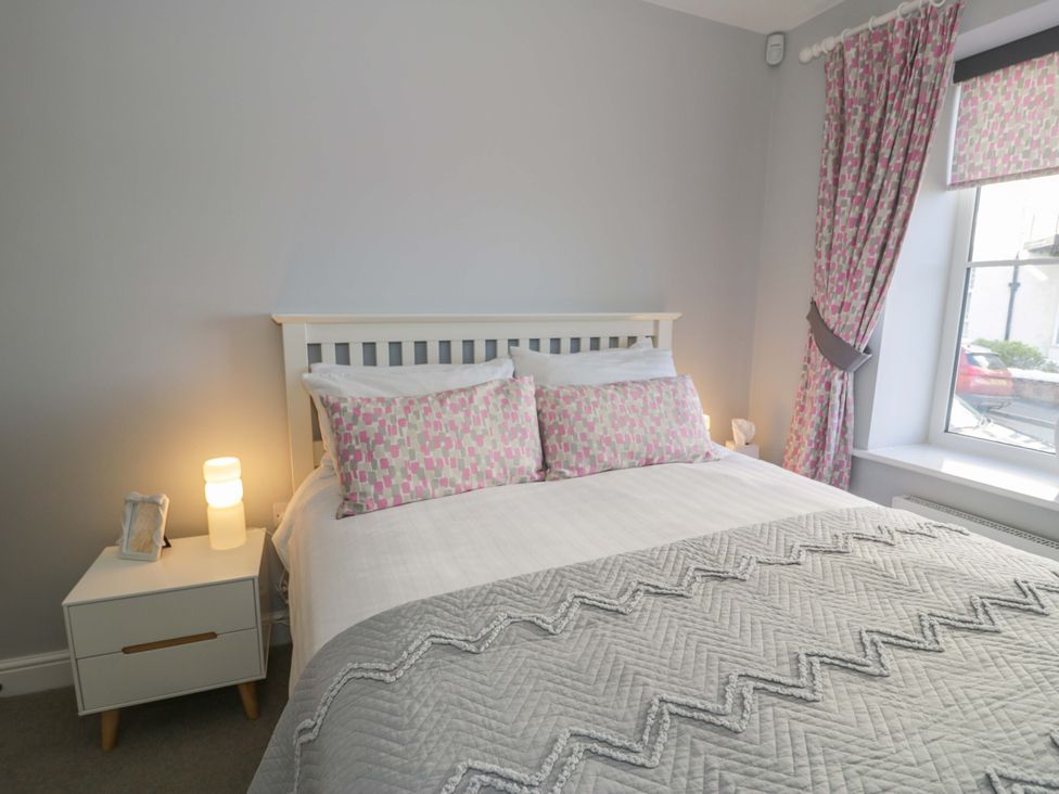 A bedroom with a bed and bedside table at Ocean View Apartment in Colwyn Bay
