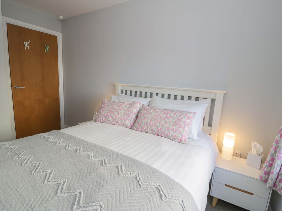 A bedroom with a bed and bedside table at Ocean View Apartment in Colwyn Bay