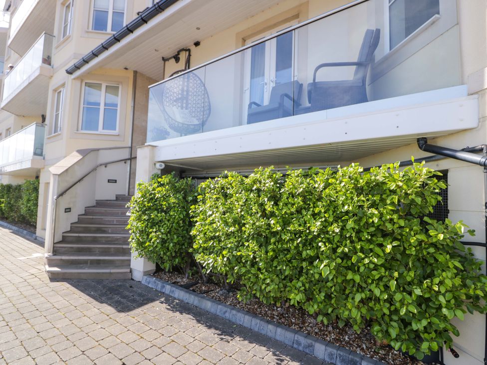 An outdoor view of a building with a balcony and steps at Ocean View Apartment in Colwyn Bay