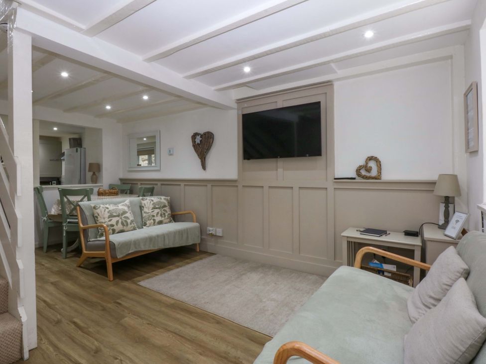 A living room with a sofa and television at 27 Kingshead Street Pwllheli