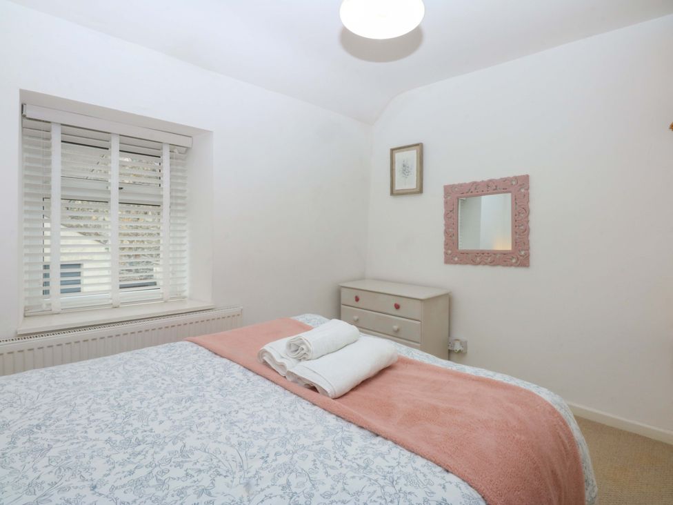 A bedroom with a bed and dresser at 27 Kingshead Street Pwllheli