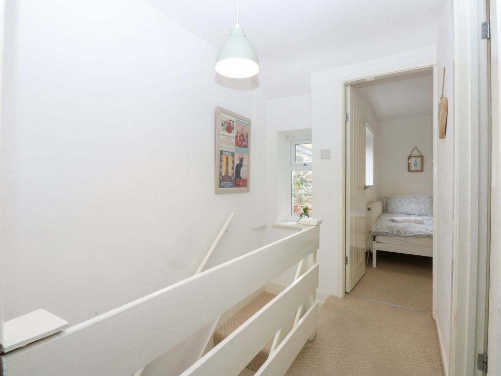 A hallway with a bed in a room at 27 Kingshead Street Pwllheli