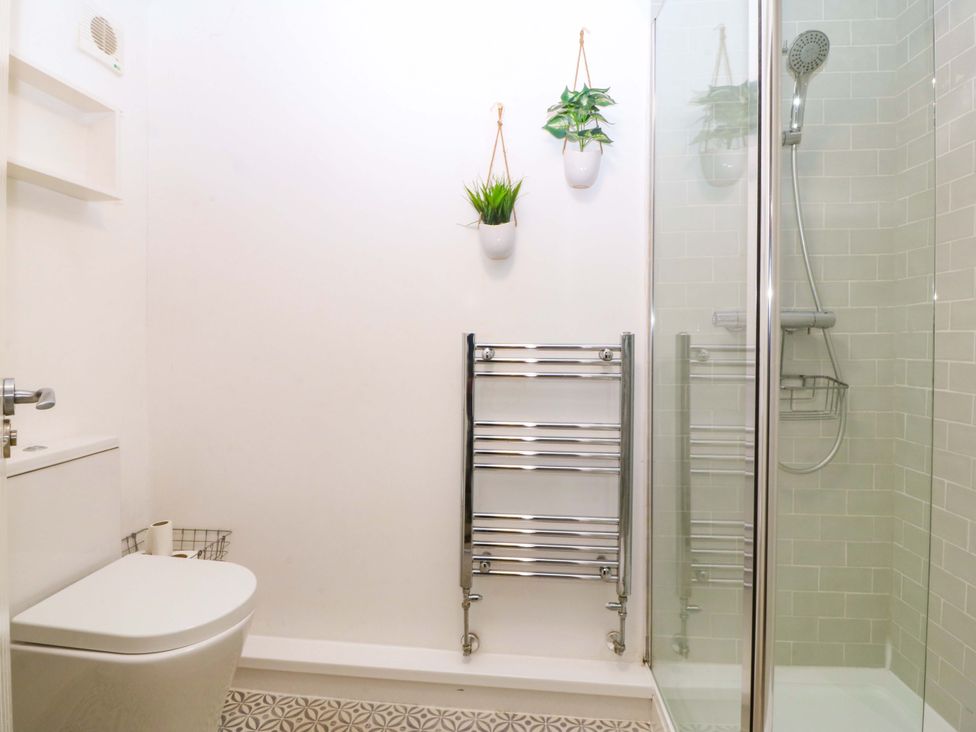 A bathroom with a shower and a toilet at 27 Kingshead Street Pwllheli