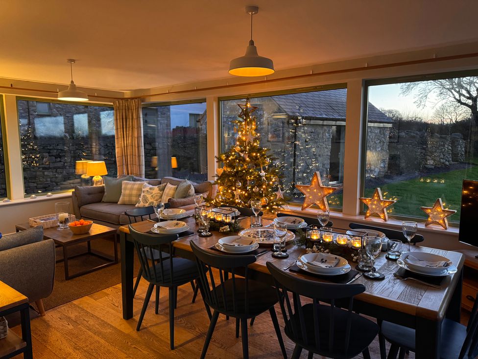 A dining room with a table set for dinner at Dolwaenydd in Brynsiencyn