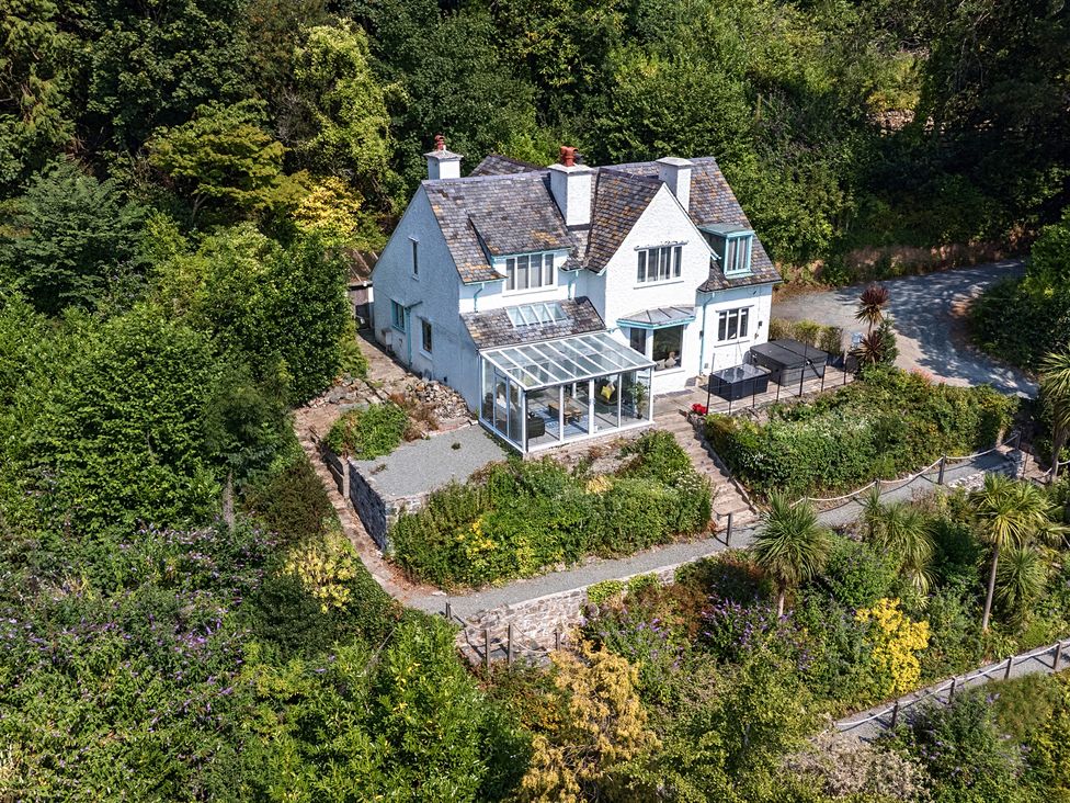 A house with a glass conservatory and garden at Afallon in Menai Bridge