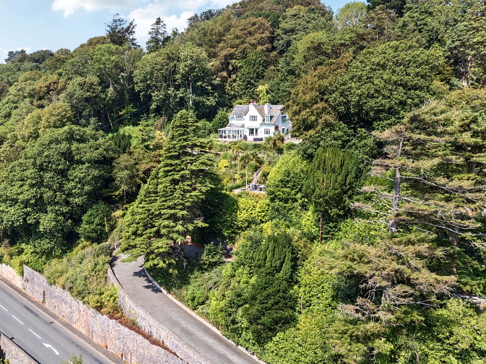 A house on a hill surrounded by trees at Afallon in Menai Bridge