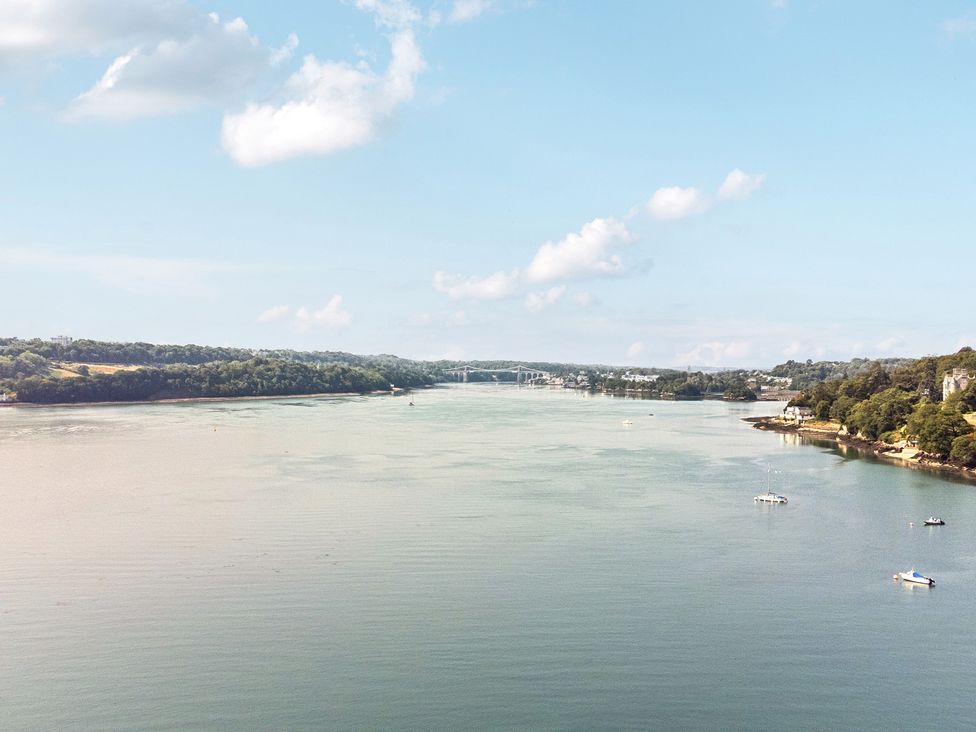 A view of a river with boats on the water at Afallon in Menai Bridge