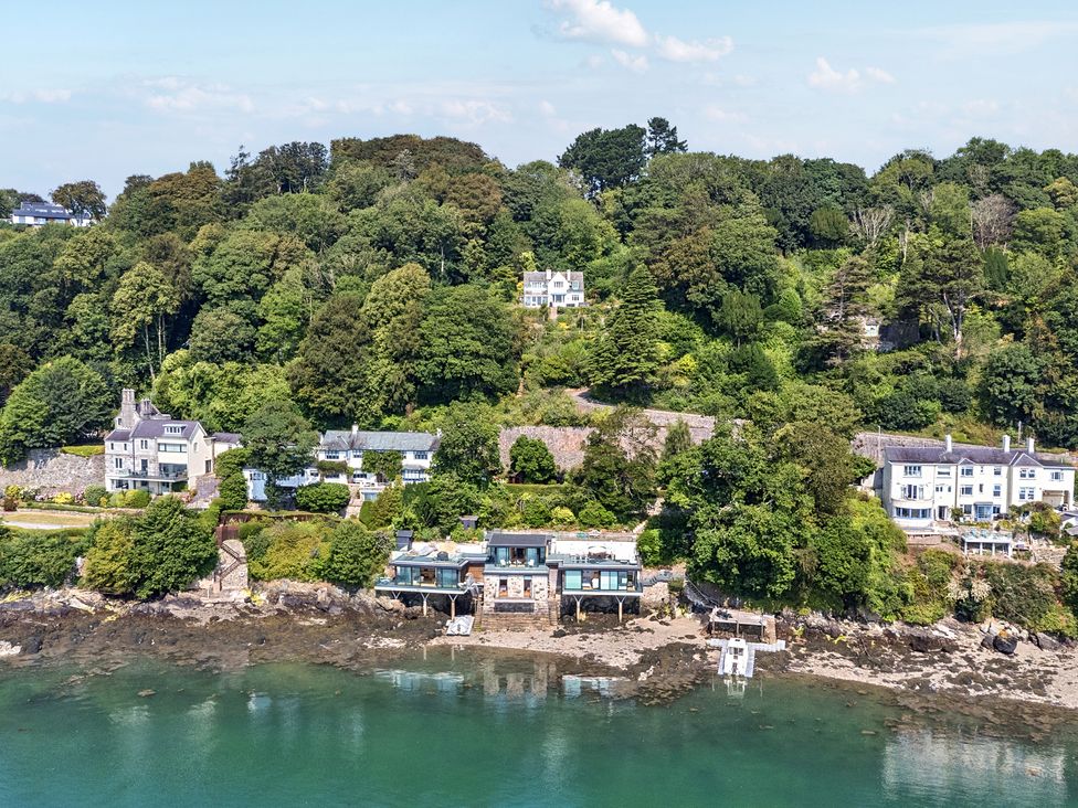 A view of houses on a hillside by the water at Afallon in Menai Bridge