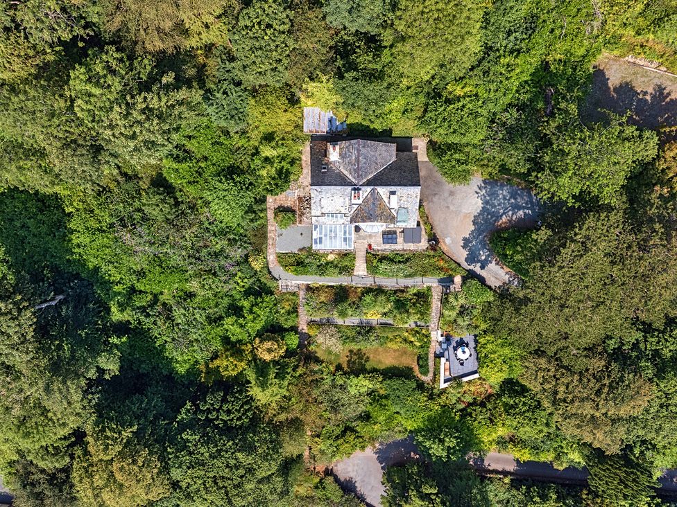 An aerial view of a house surrounded by garden and trees at Afallon in Menai Bridge