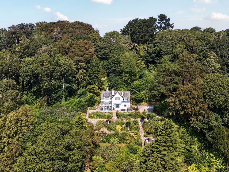 A house surrounded by trees and gardens at Afallon in Menai Bridge