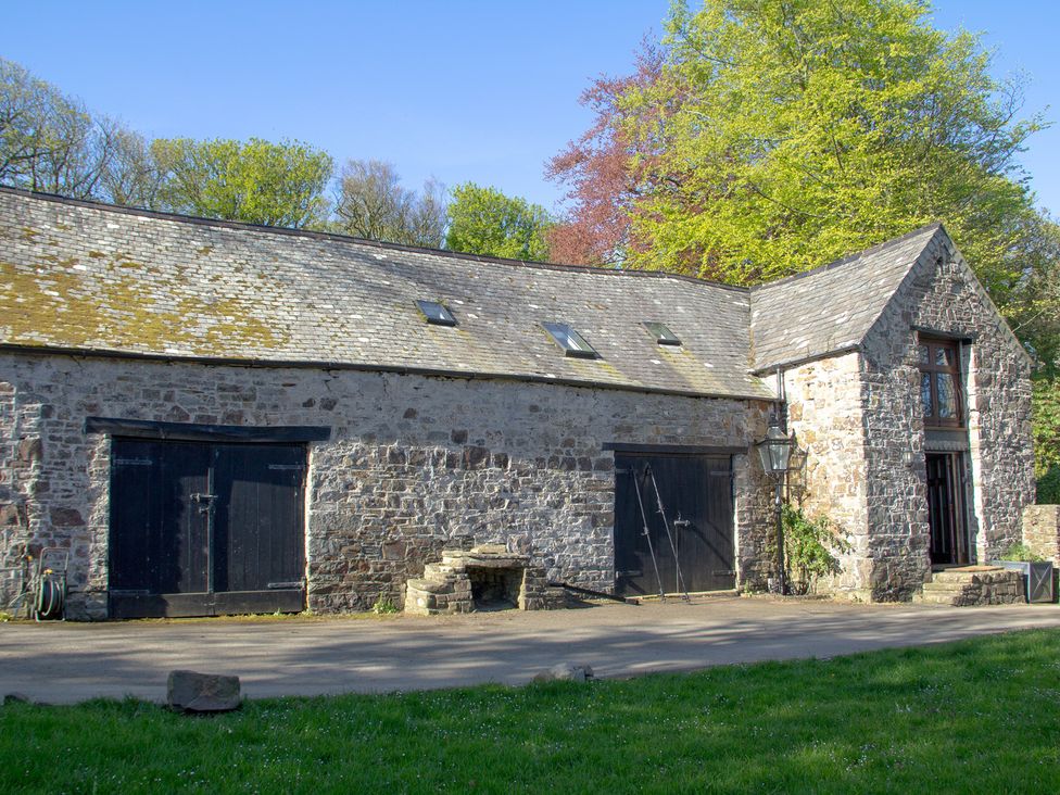 An exterior view of a stone building with two doors at Carrows Stable Morwenstow