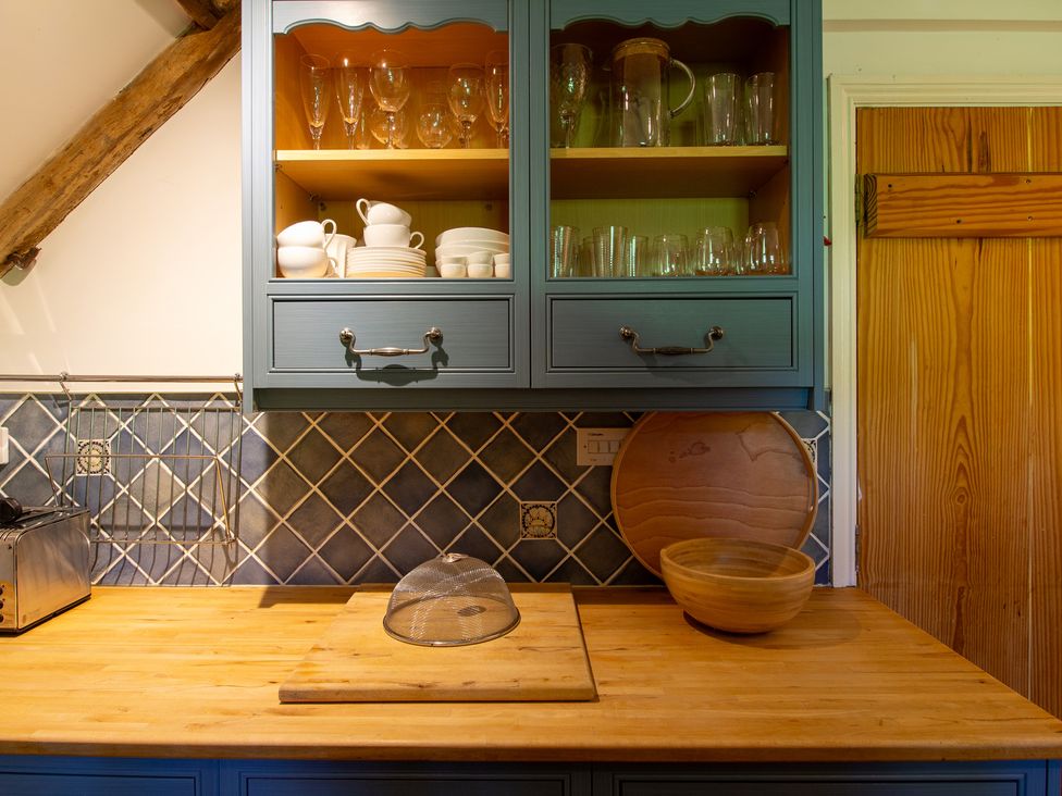 A kitchen with cabinets and kitchenware at Carrows Stable Morwenstow