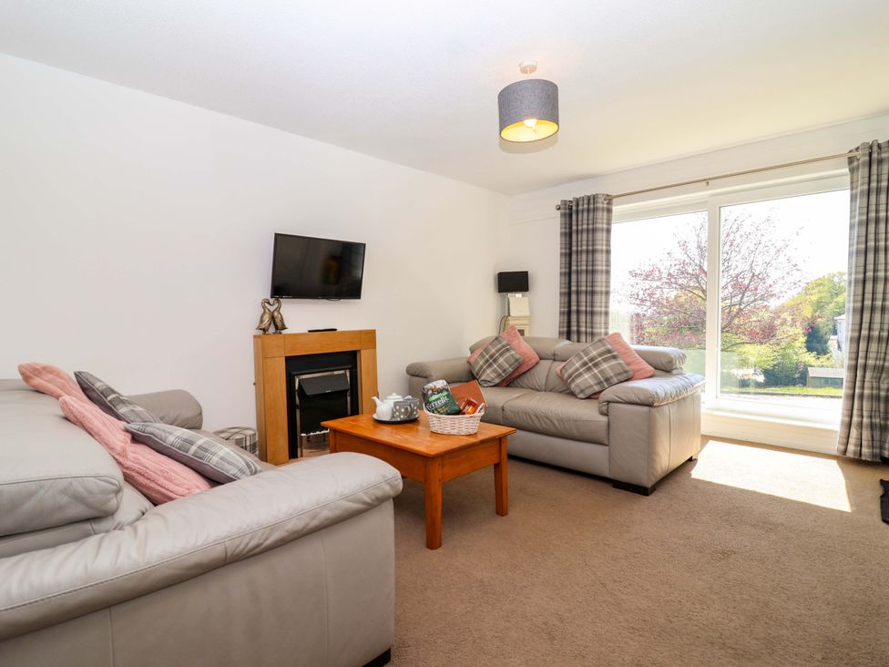 A living room with a sofa and coffee table at 13 Manorcombe Bungalows Honicombe Holiday Village near Gunnislake