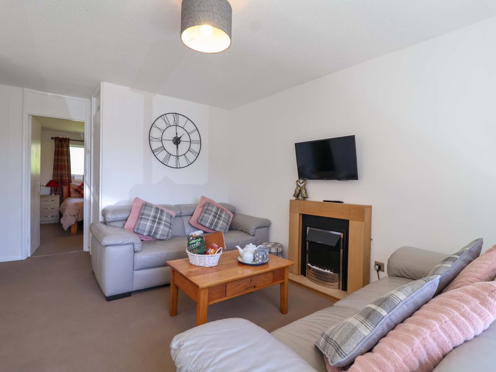 A living room with a sofa and coffee table at 13 Manorcombe Bungalows Honicombe Holiday Village near Gunnislake
