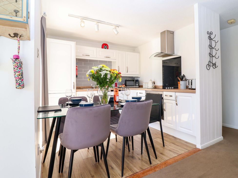 A kitchen with a dining table and chairs at 13 Manorcombe Bungalows Honicombe Holiday Village near Gunnislake
