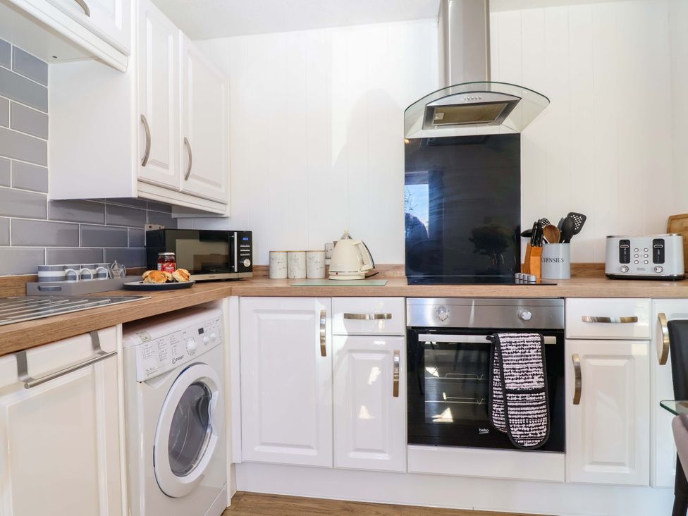 A kitchen with appliances and utensils at 13 Manorcombe Bungalows Honicombe Holiday Village near Gunnislake