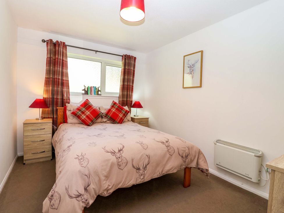 A bedroom with a double bed and bedside tables at 13 Manorcombe Bungalows Honicombe Holiday Village near Gunnislake