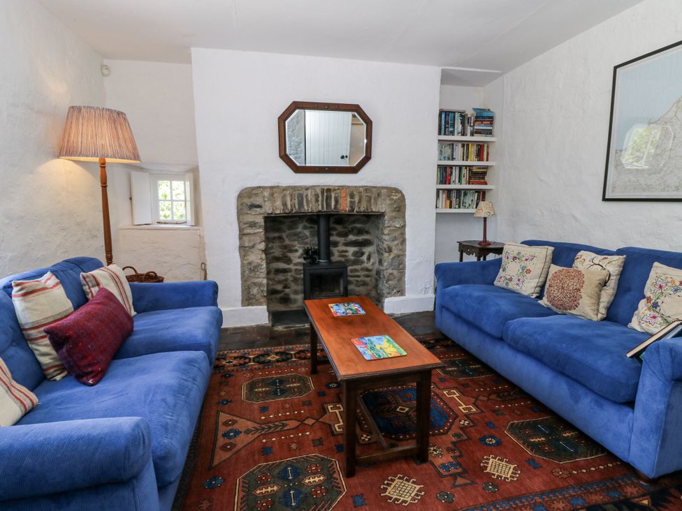 A living room with sofas and a coffee table at Dolwylan Cottage in Cwmtydu near New Quay