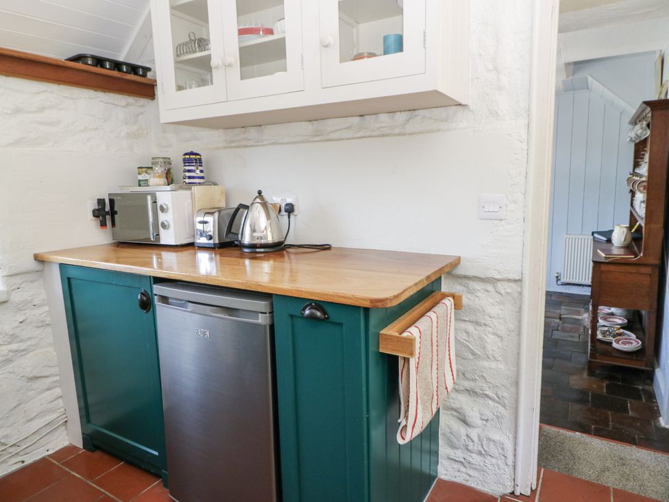 A kitchen with a kettle and microwave at Dolwylan Cottage Cwmtydu near New Quay