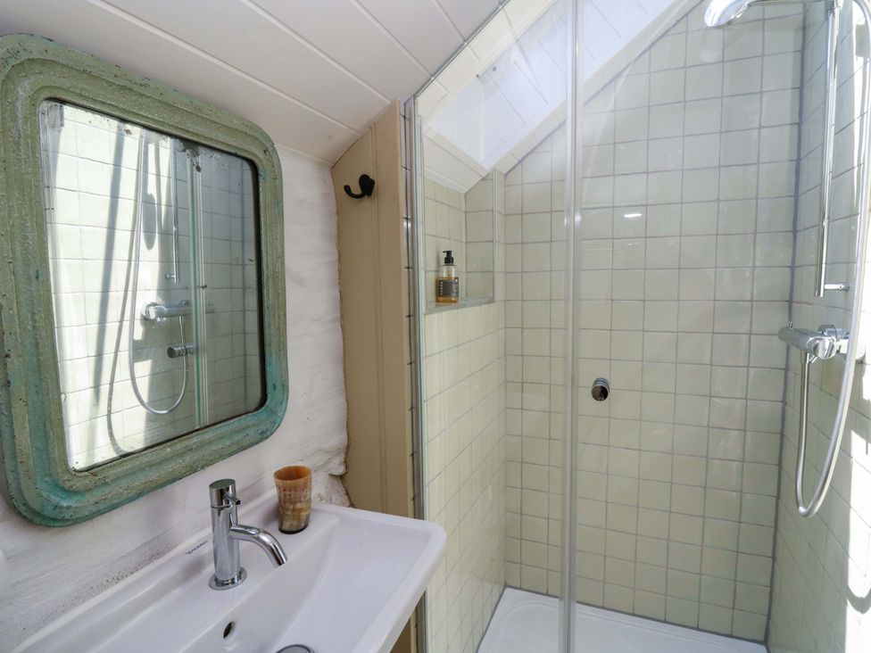 A bathroom with a sink and shower at Dolwylan Barn Cwmtydu near New Quay