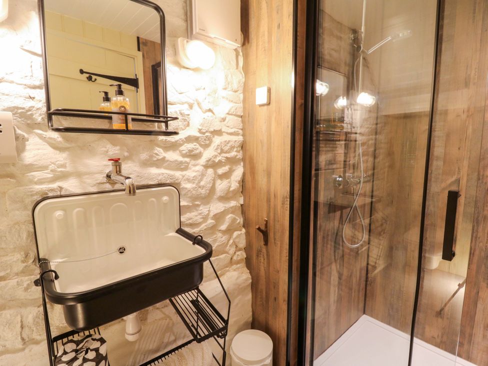 A bathroom with a sink and shower at Dolwylan Barn Cwmtydu near New Quay