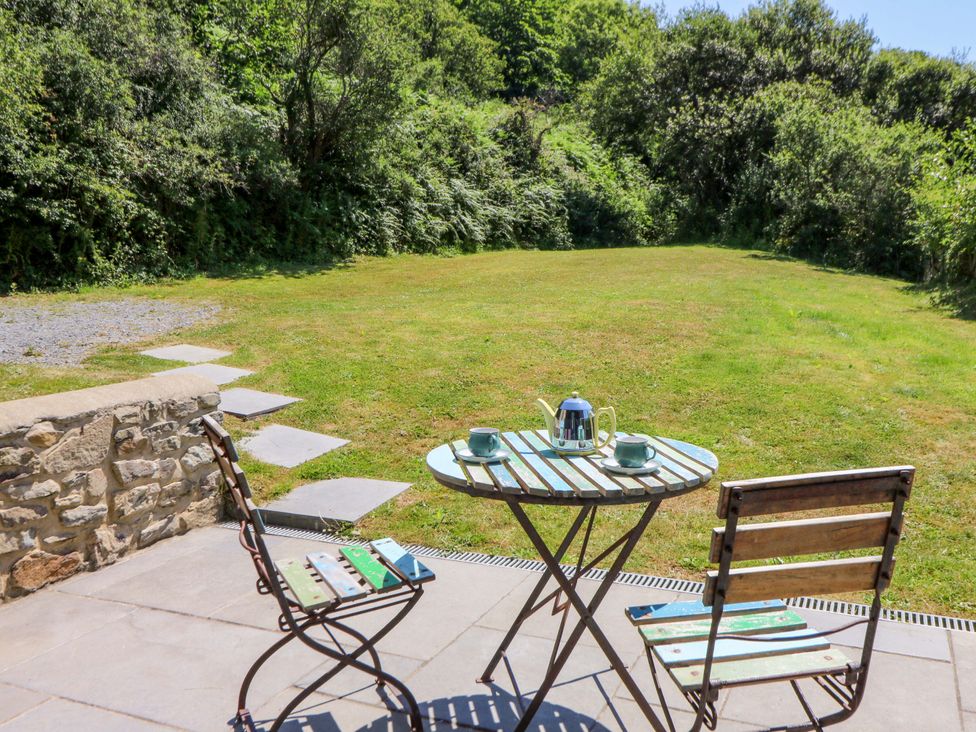 A table with chairs and teapot at Dolwylan Barn in Cwmtydu near New Quay
