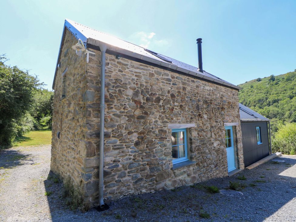 An outdoor view of a stone cottage at Dolwylan Barn in Cwmtydu near New Quay