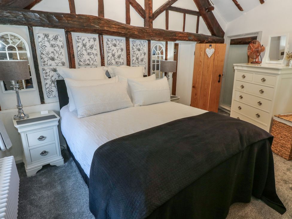 A bedroom with a bed and bedside table at Lydgate Cottage in Eyam