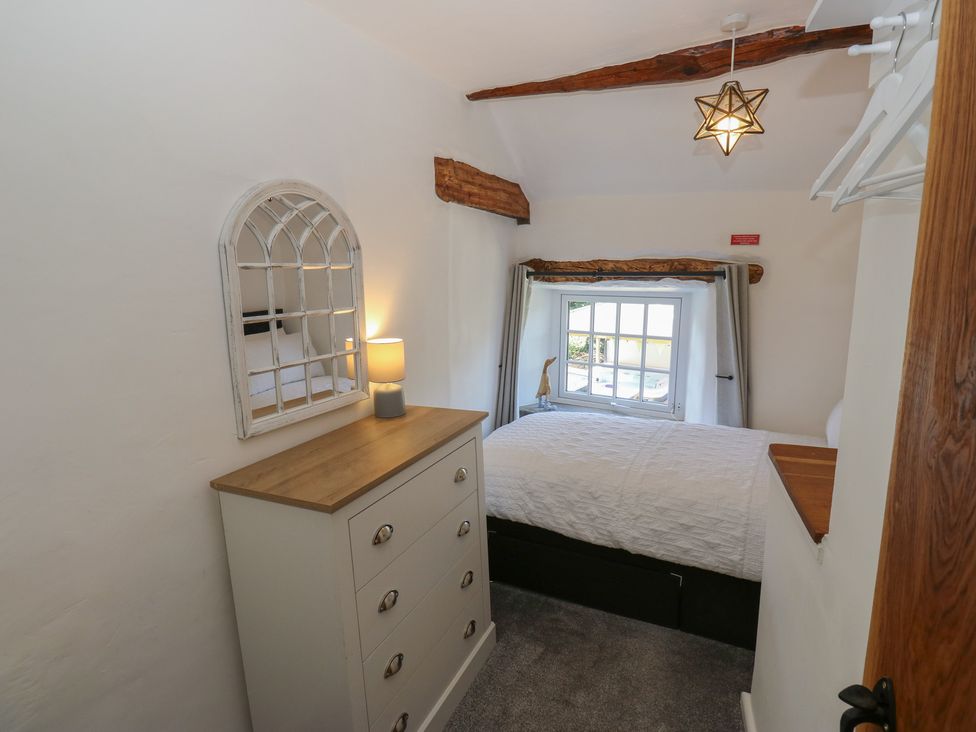 A bedroom with a bed and a chest of drawers at Lydgate Cottage in Eyam