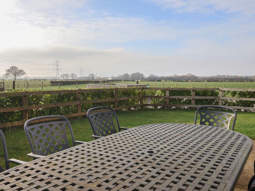 A patio area with a table and chairs at The Cart House near Cuckoo Nest Farm near Wilberfoss