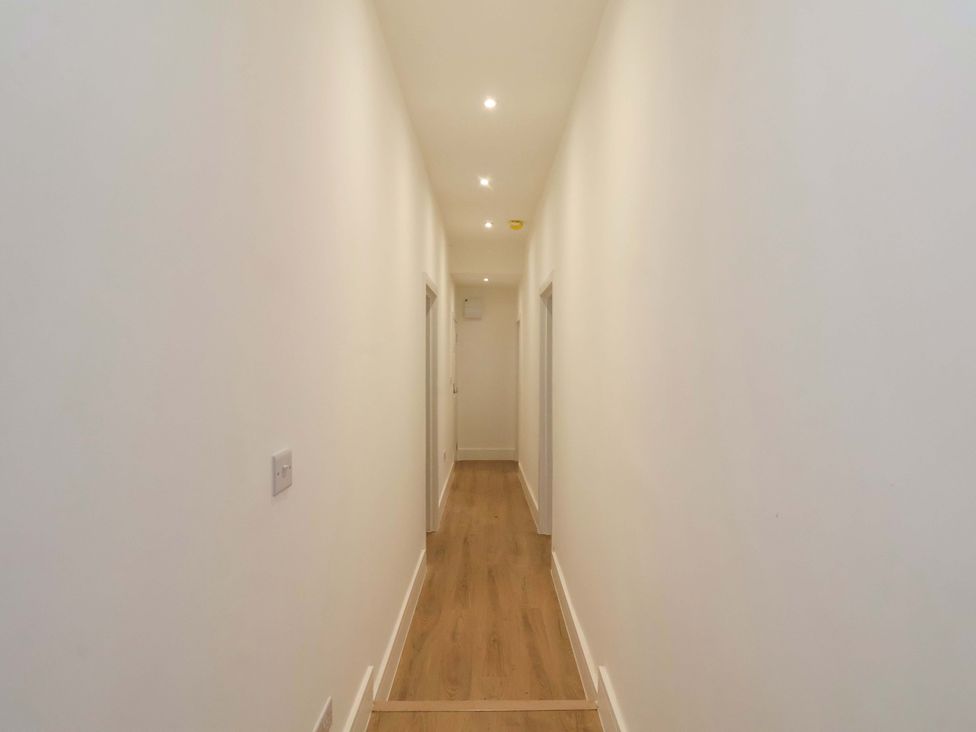 A hallway with light fixtures and doors at Beachwalk Villa 1