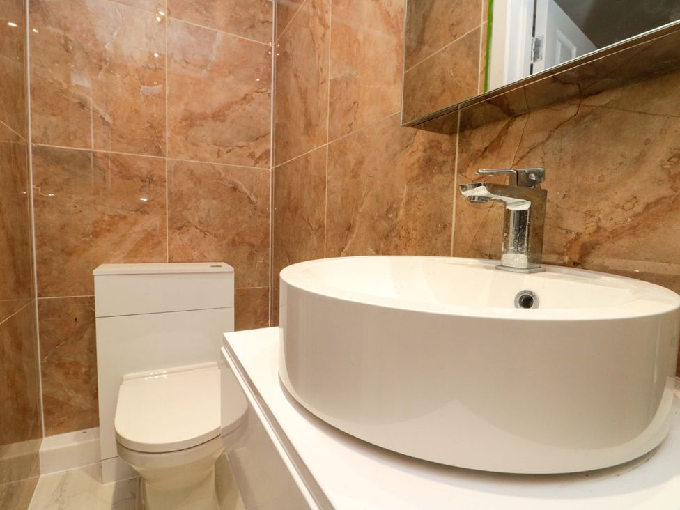 A bathroom with a sink and toilet at Beachwalk Villa 1