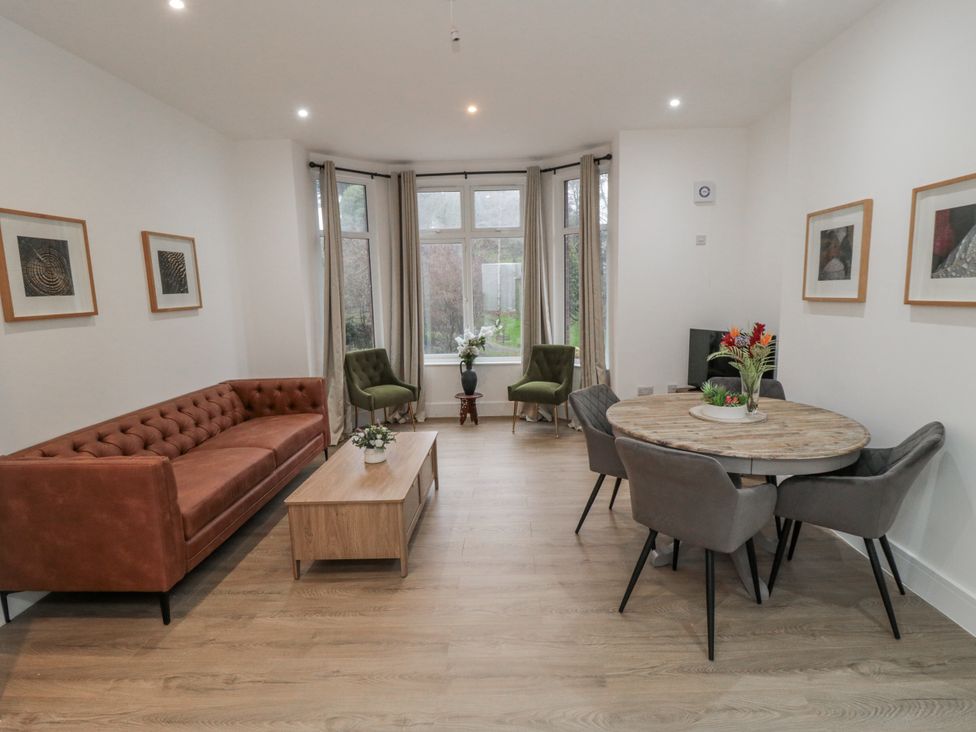 A living room with a sofa and dining area at Beachwalk Villa 1 in Whitby
