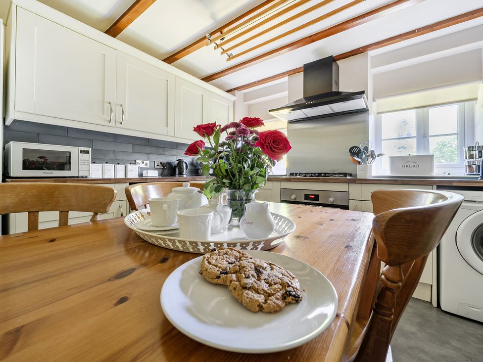 A kitchen with a table and chairs at Tyn Y Ffynnon in Betws-Y-Coed