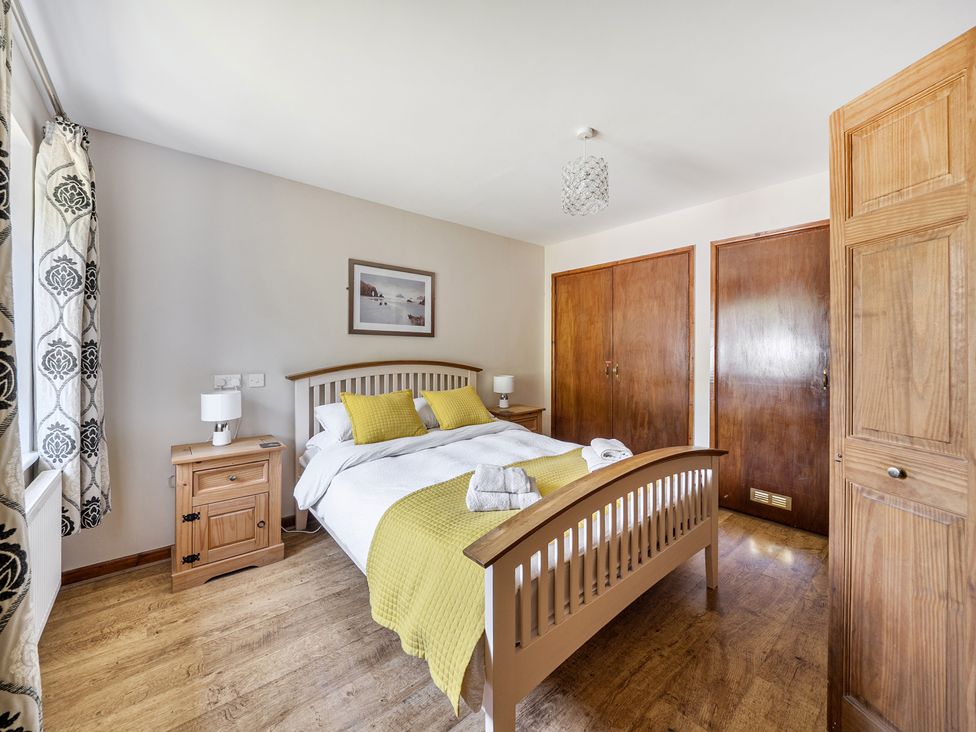 A bedroom with a bed and a nightstand at Tyn Y Ffynnon in Betws-Y-Coed