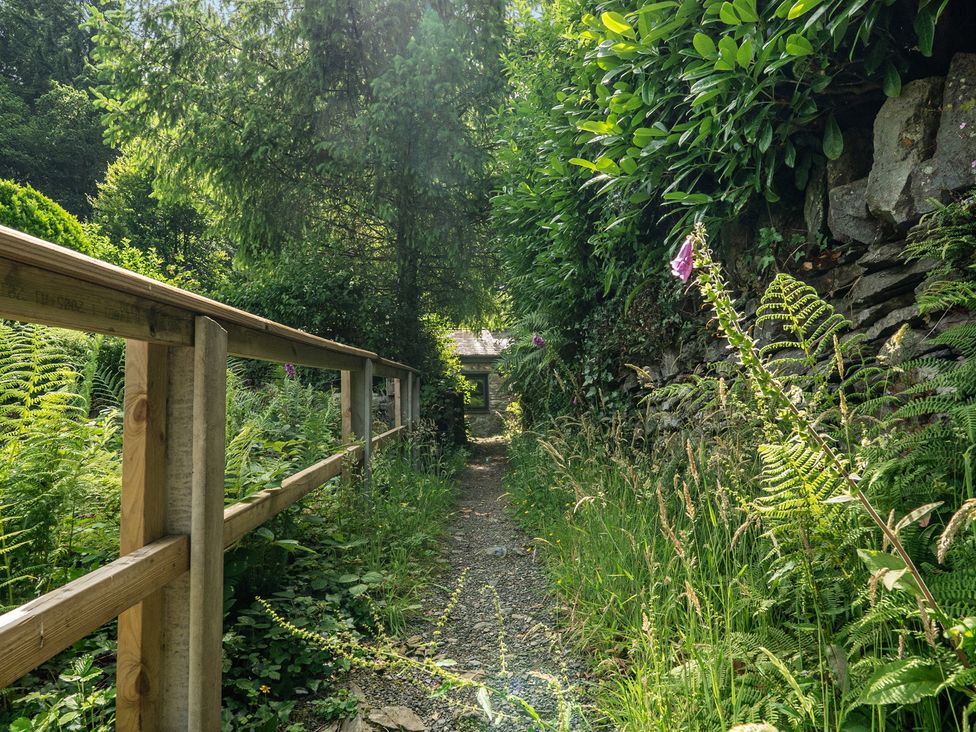 A path surrounded by plants and a fence at Tyn Y Ffynnon in Betws-Y-Coed