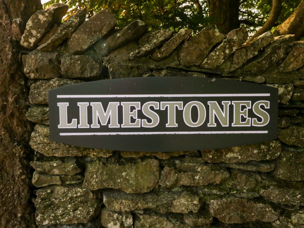 A sign reading 'LIMESTONES' on a stone wall at Limestone in Great Urswick