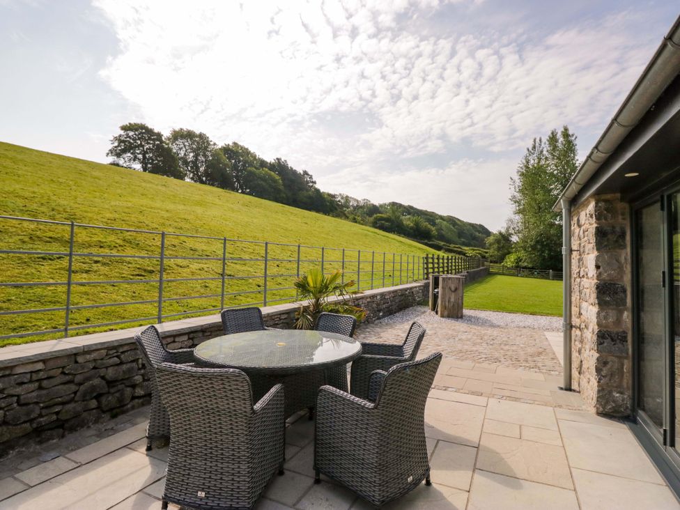 A patio with a table and chairs at Limestone in Great Urswick