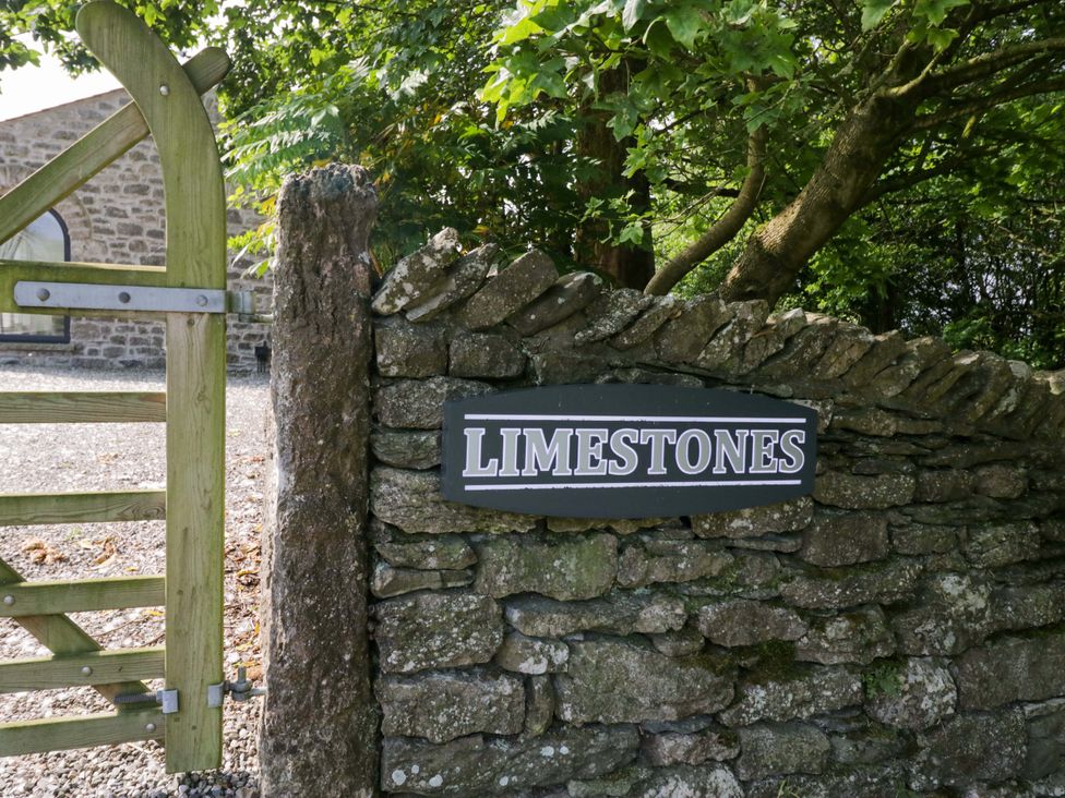 A sign labeled Limestones on a stone wall at Limestone in Great Urswick