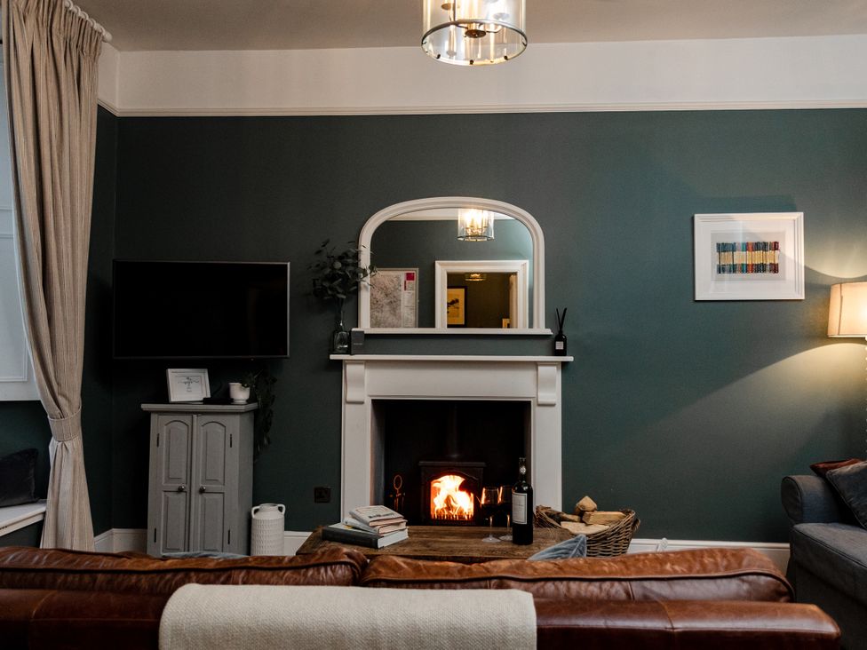 A living room with a fireplace and sofa at Pendle View Luxury Apartment in Giggleswick near Settle