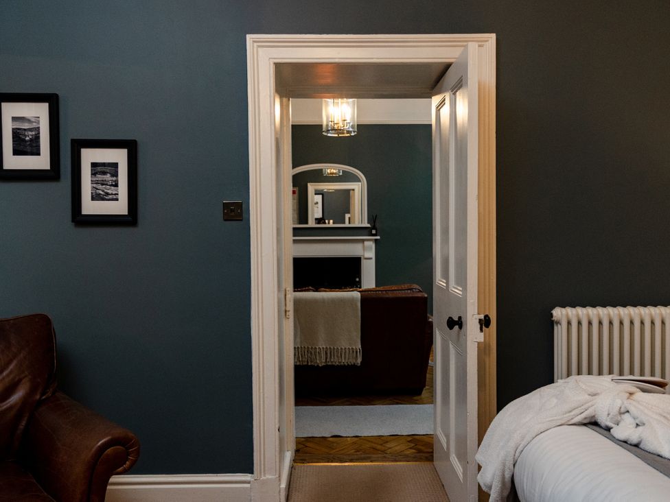 A bedroom with a view to a living room at Pendle View Luxury Apartment in Giggleswick near Settle