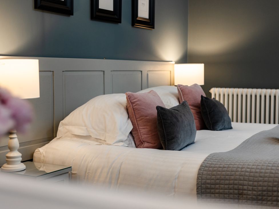 A bedroom with a bed and bedside lamps at Pendle View Luxury Apartment in Giggleswick near Settle