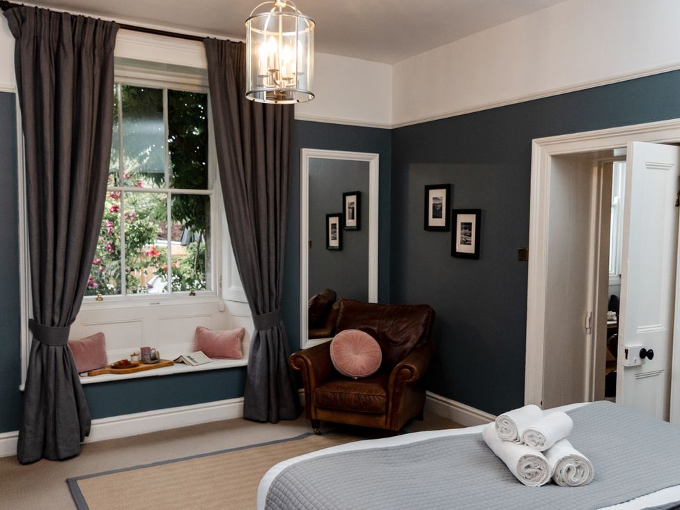 A bedroom with a window and chair at Pendle View Luxury Apartment in Giggleswick near Settle