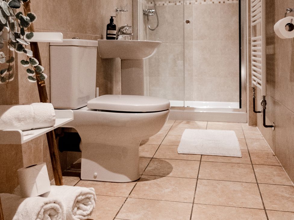 A bathroom with a toilet, sink, and shower at Pendle View Luxury Apartment in Giggleswick near Settle