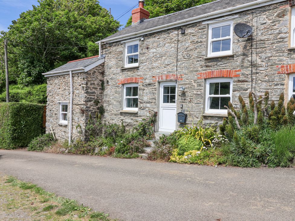 A stone house with a garden at 2 Cliff Cottages in West Portholland near Gorran Haven
