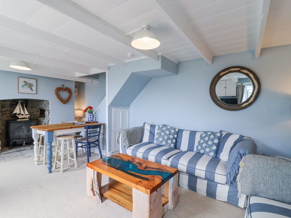 A living room with a sofa and coffee table at 2 Cliff Cottages in West Portholland near Gorran Haven