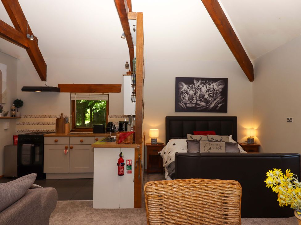A kitchen and living area with furniture at Little Torr in Drewsteignton