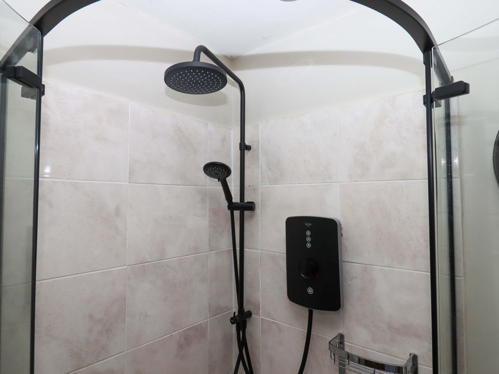 A shower with a wall-mounted showerhead at Little Torr in Drewsteignton