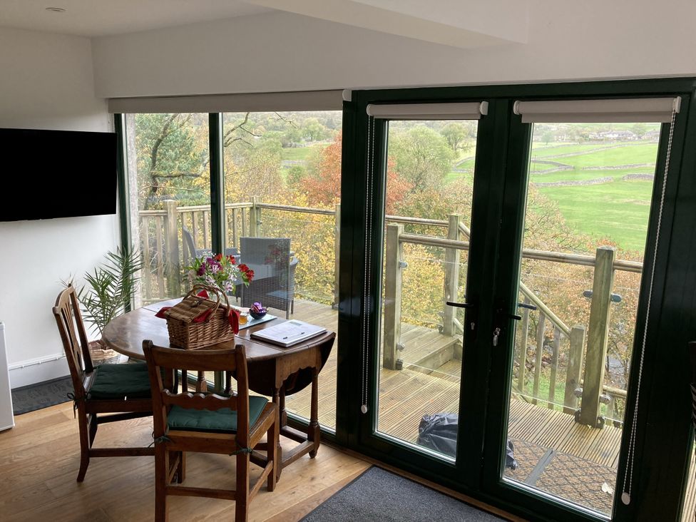 A dining room with a table and chairs at The Sett on the Wharfe Skipton