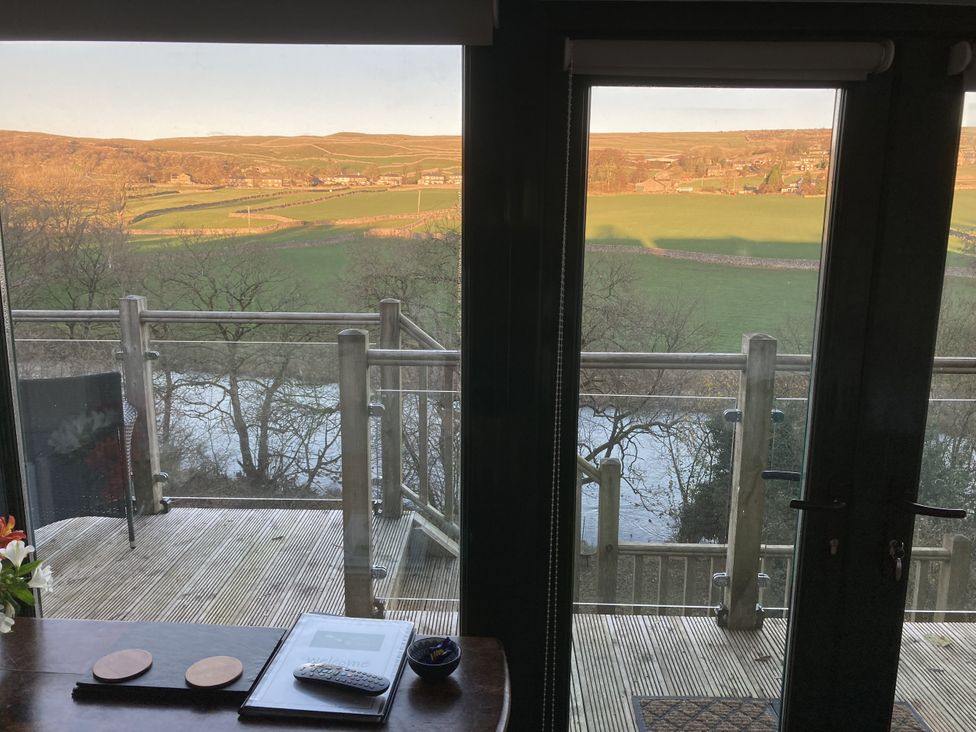 A balcony view overlooking fields and river at The Sett on the Wharfe in Skipton